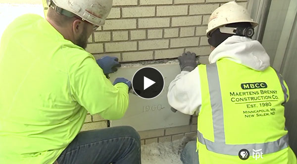 Men remove the KTCA time capsule