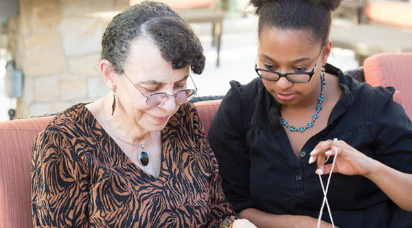 Young woman helping older woman